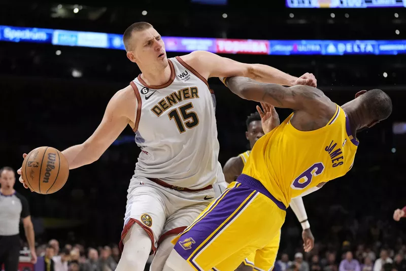 Denver Nuggets center Nikola Jokic collides with Los Angeles Lakers forward LeBron James