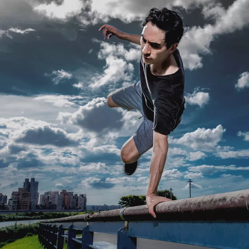 Man doing stunt on railing