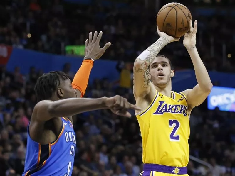 Lonzo Ball shoots against Jerami Grant of Oklahoma City Thunder