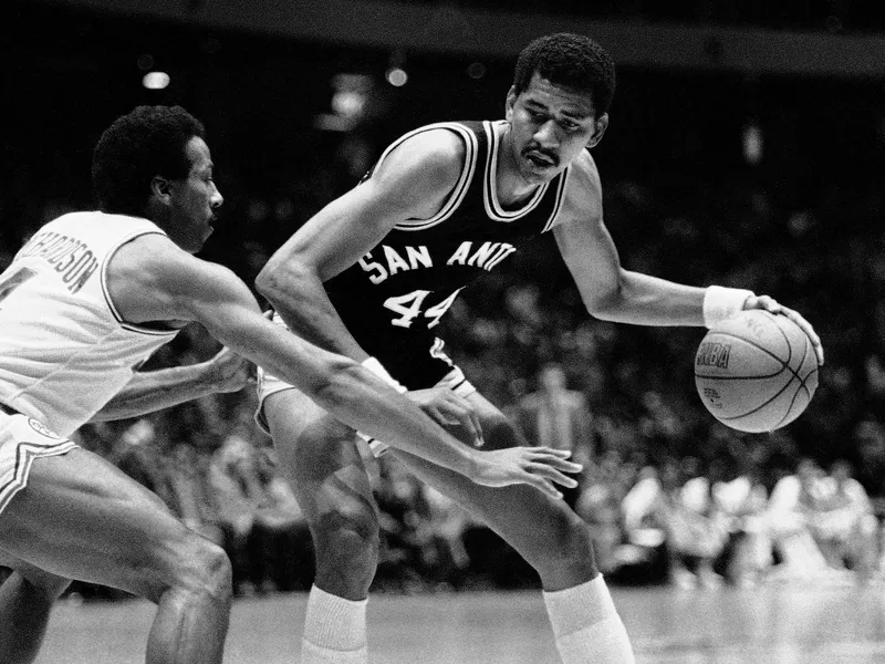 San Antonio Spurs' George Gervin tries to dribble around guard