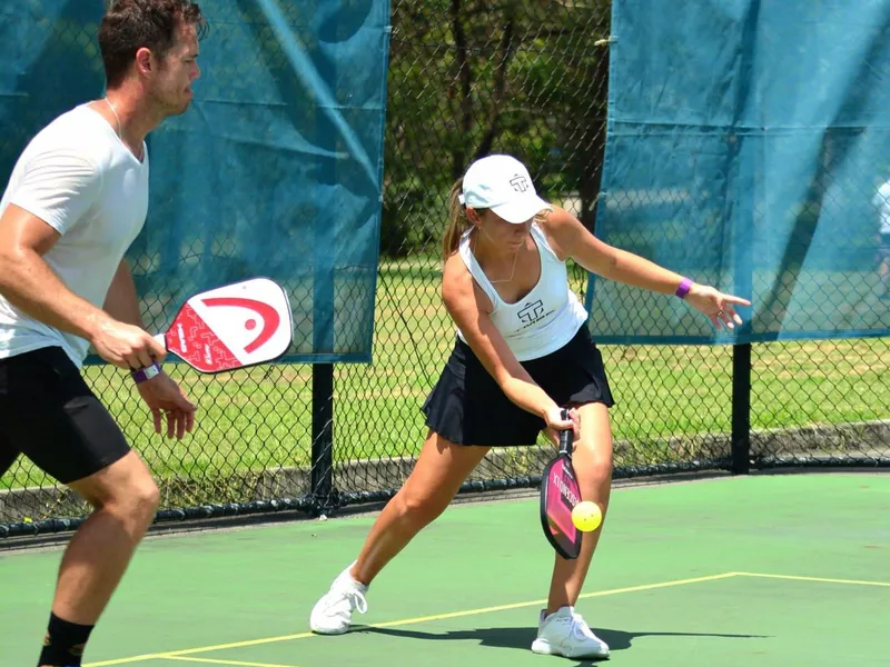 Woman and man playing pickleball