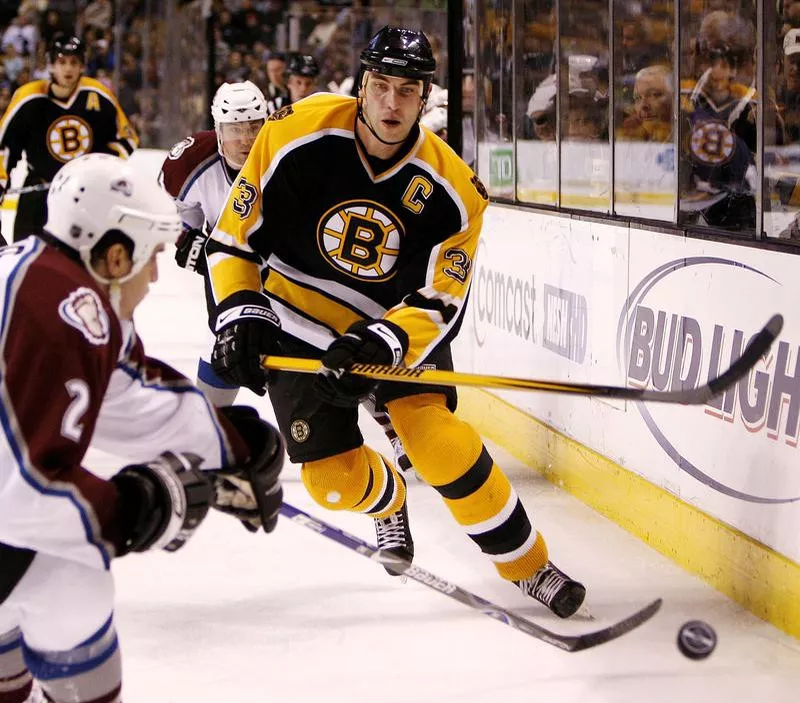 Boston Bruins defenseman Zdeno Chara dumps puck into corner against Colorado Avalanche