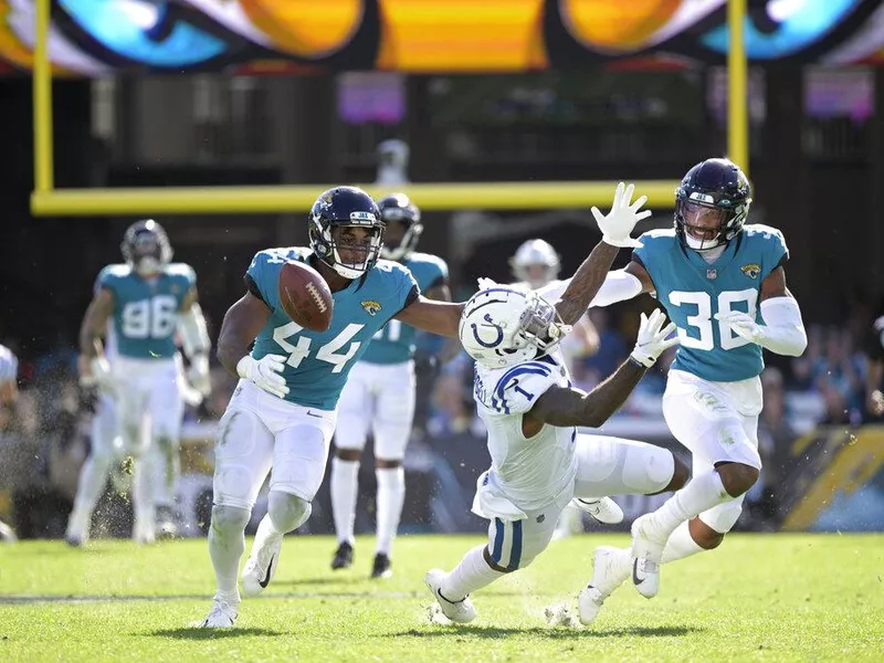 Jaguars defenders Myles Jack and Andre Cisco defend against Colts wide receiver Parris Campbell