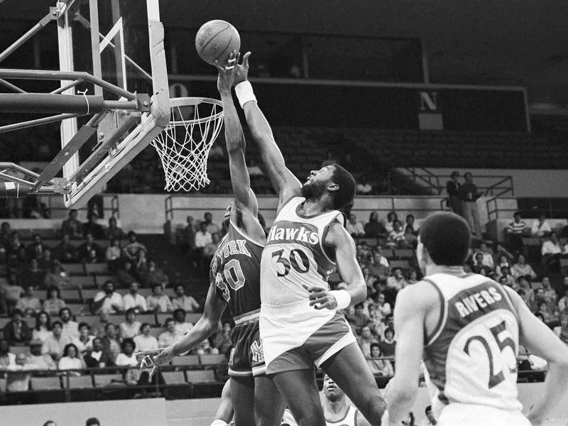 New York Knicks' Bernard King has his shot blocked by Tree Rollins