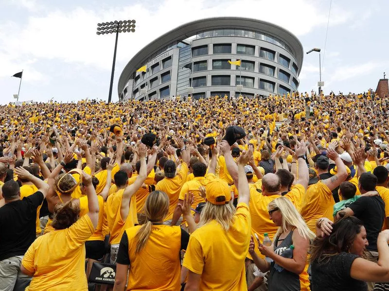 Fans wave to the Iowa Children's Hospital