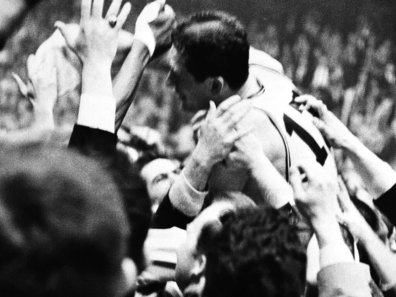 Boston Celtics swingman John Havlicek celebrates with fans