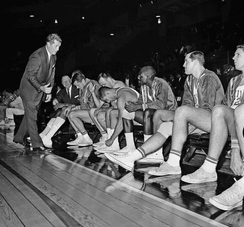 Philadelphia Warriors team sits on bench