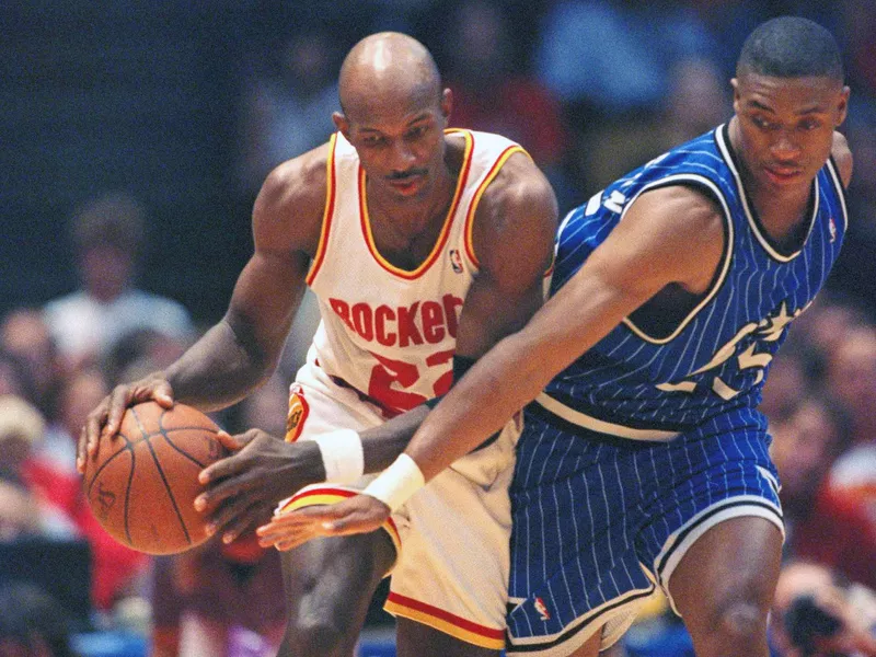 Clyde Drexler drives past Orlando Magic guard Nick Anderson