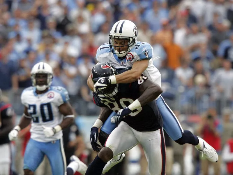 Tennessee Titans defensive back Cortland Finnegan grabs Houston Texans wide receiver Andre Johnson