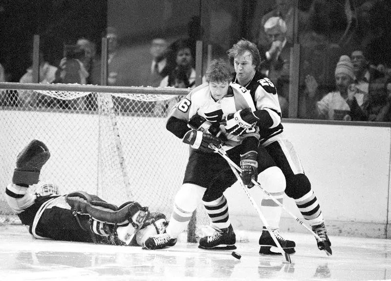 Bobby Clarke prepares to pass puck