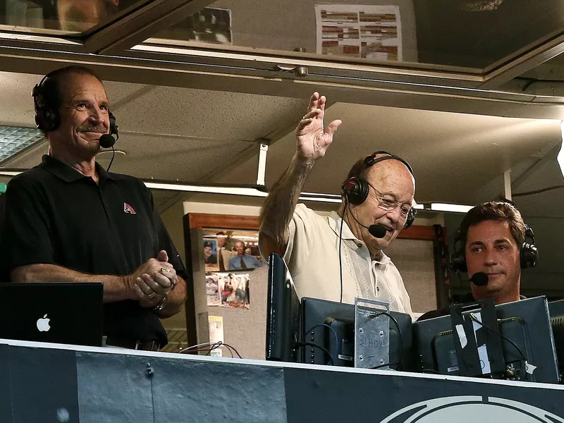 Joe Garagiola waves to fans