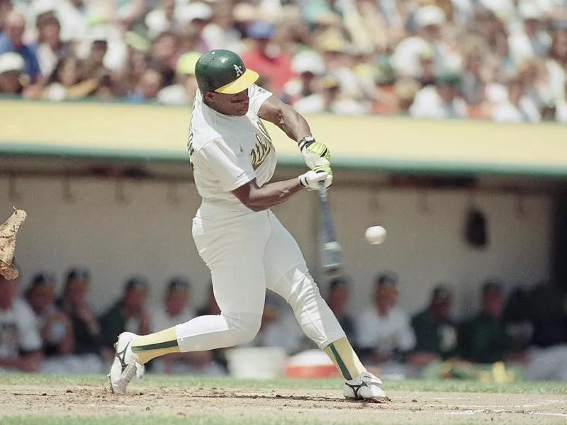 Rickey Henderson making contact with ball