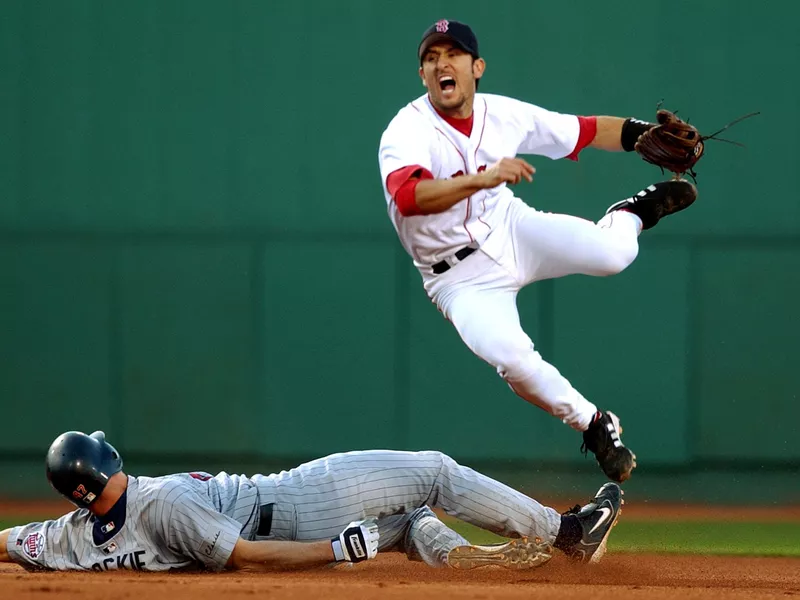 Boston Red Sox shortstop Nomar Garciaparra leaps after throwing the ball