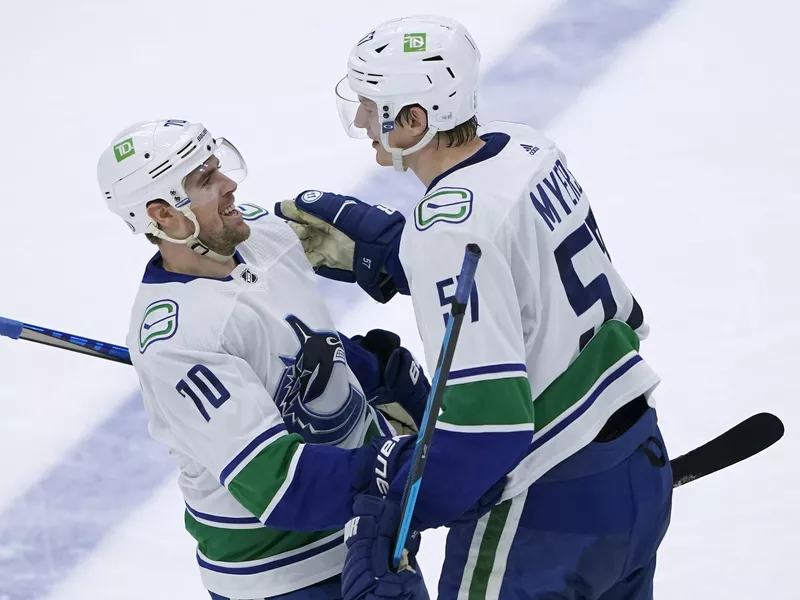 Tyler Myers celebrates with Tanner Pearson