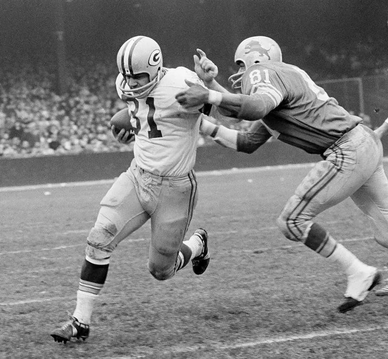 Dick Lane brings down Jim Taylor in Detroit