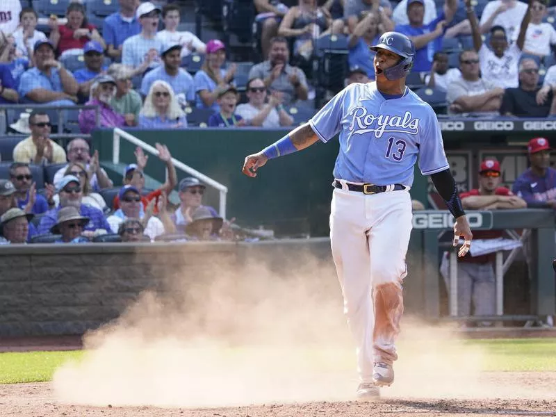 Salvador Perez celebrates after scoring a run