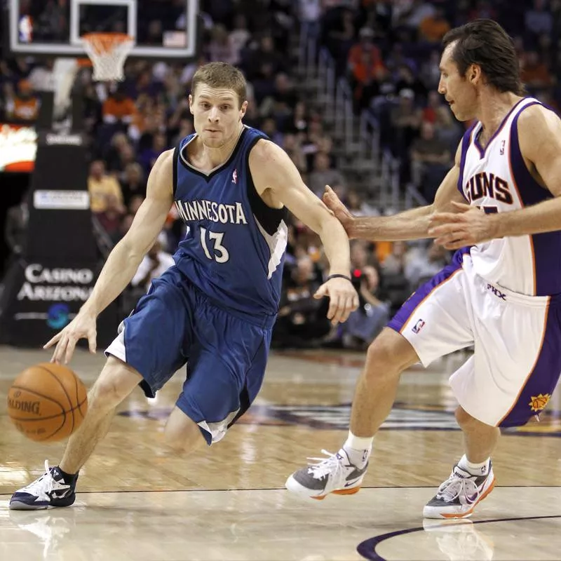 Luke Ridnour dribbles past Phoenix Suns' Steve Nash