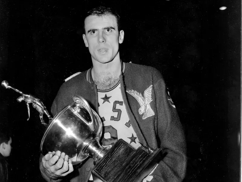 Bob Pettit holds up MVP trophy