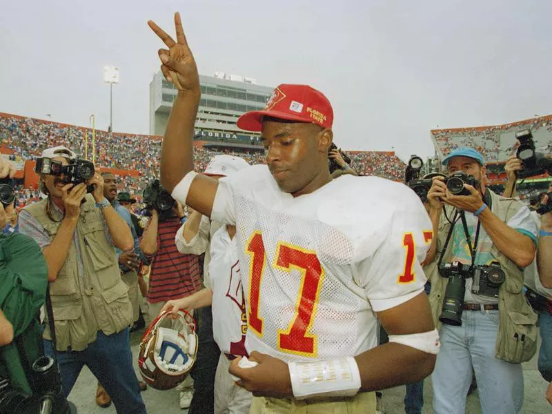 Florida State quarterback Charlie Ward flashes victory sign