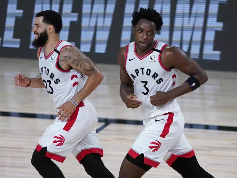 Toronto Raptors' Fred VanVleet and OG Anunoby react