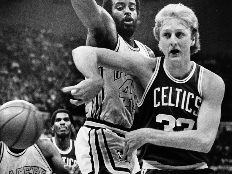 Larry Bird passes ball off