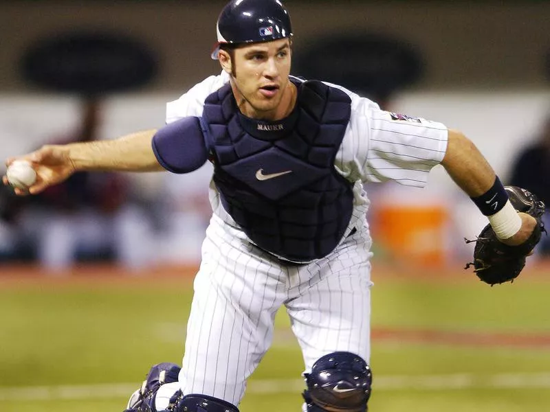 Joe Mauer looks to throw the ball