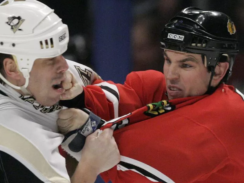 Pittsburgh Penguin Lyle Odelein and Chicago Blackhawk Matthew Barnaby mix it up