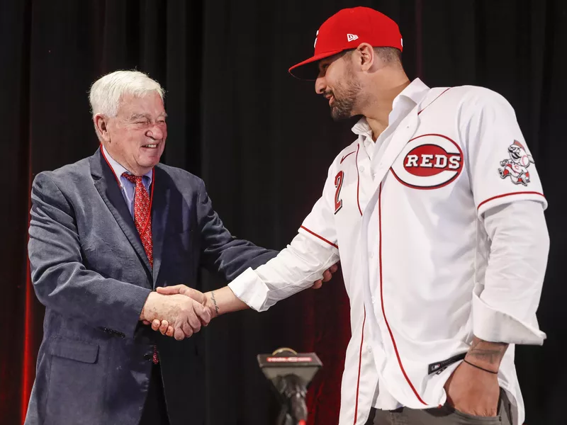 Cincinnati Reds Nick Castellanos shakes hands with Reds chief executive owner Bob Castellini