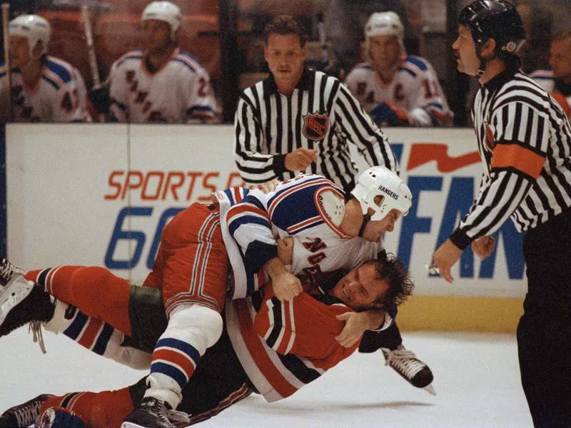 New York Ranger Troy Mallette wrestles with New Jersey Devil defenseman Ken Daneyko