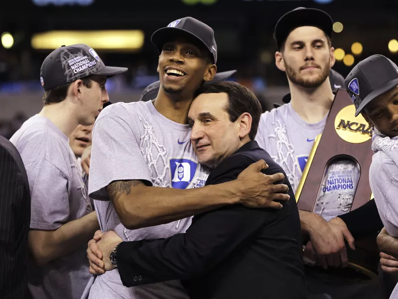 Duke coach Mike Krzyzewski and guard Lance Thomas embrace after win over Butler