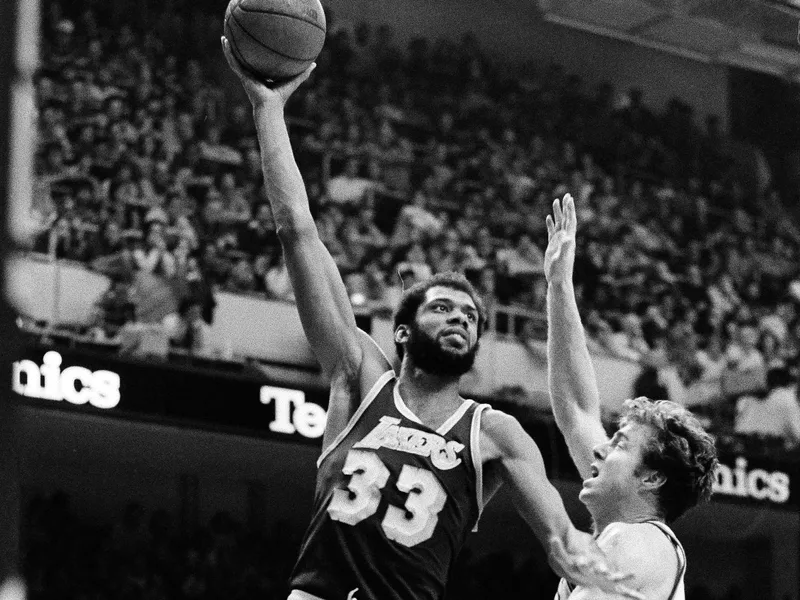 Kareem Abdul-Jabbar hooks one over Dave Cowens