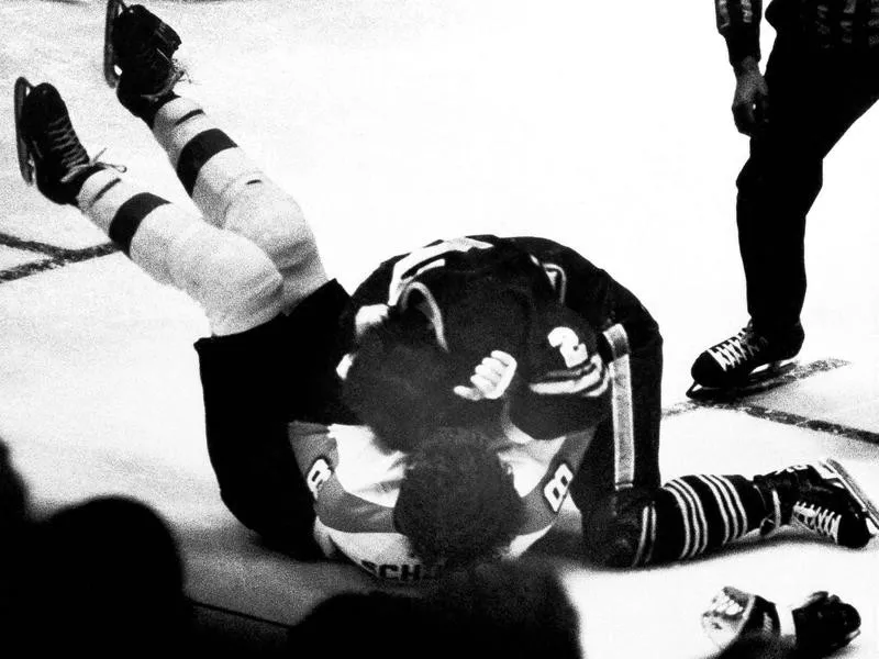 Tim Horton tackles Dave Schultz