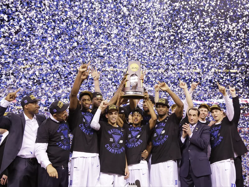 Duke players celebrate with trophy after win over Wisconsin