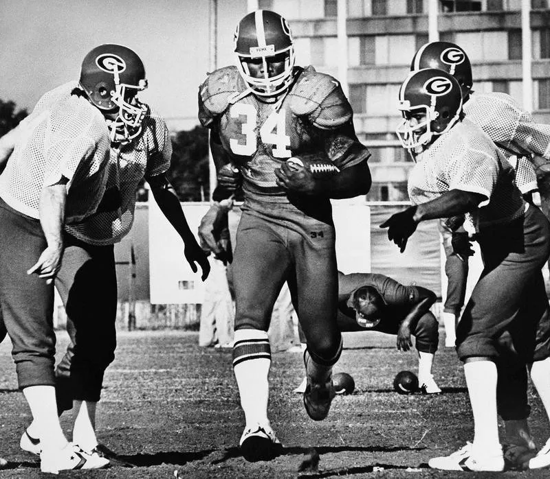 Herschel Walker carries the ball during drill