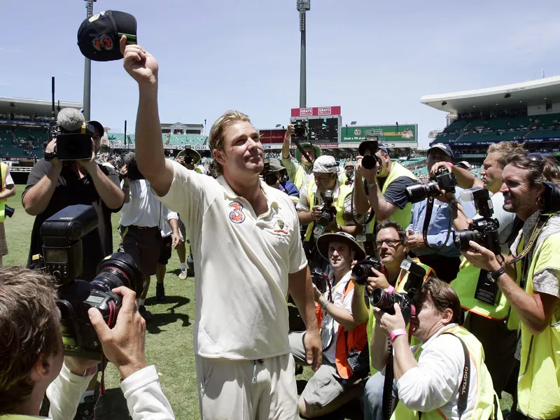 Australian bowler Shane Warne waves cap