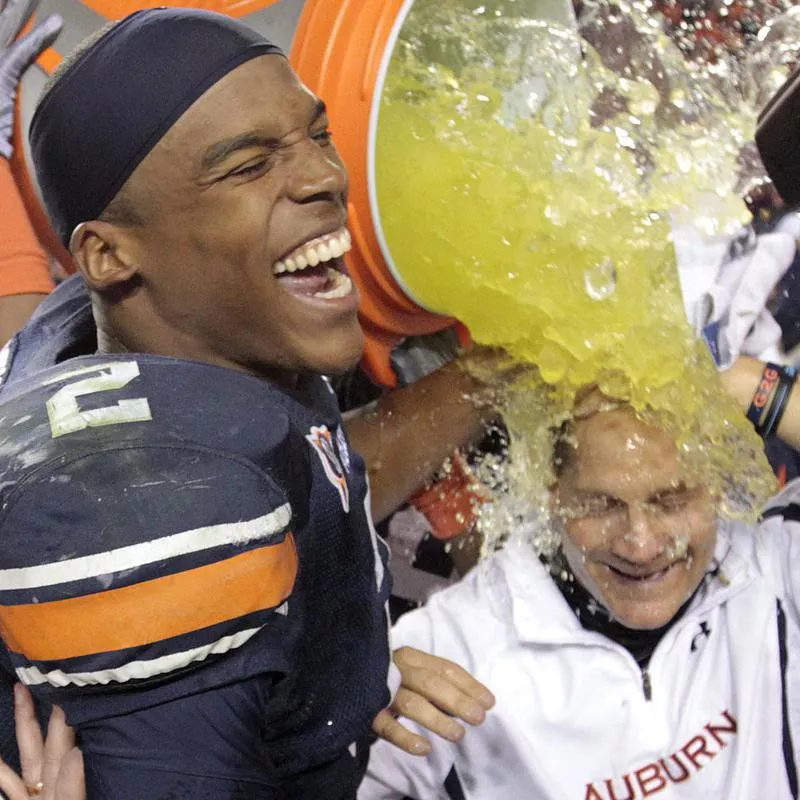 Auburn quarterback Cameron Newton dunks coach Gene Chizik