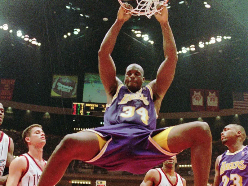 Los Angeles Lakers' Shaquille O'Neal hanging from the rim