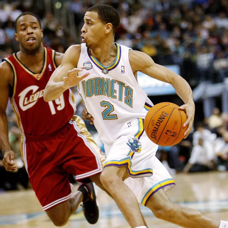 Jannero Pargo drives the ball past Cleveland Cavaliers guard Damon Jones