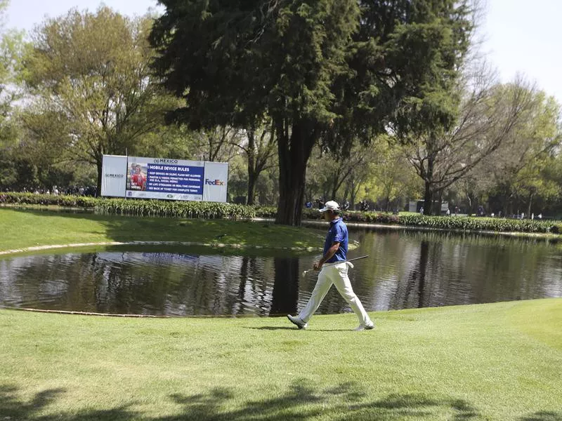 Hideki Matsuyama walks to the 7th green