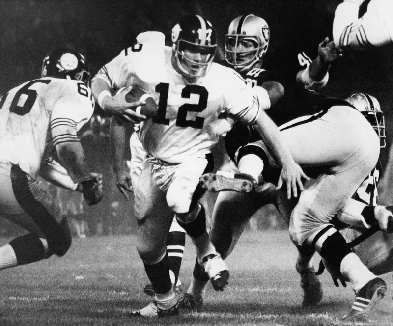 Pittsburgh Steeler rookie quarterback Terry Bradshaw picks up seven yards