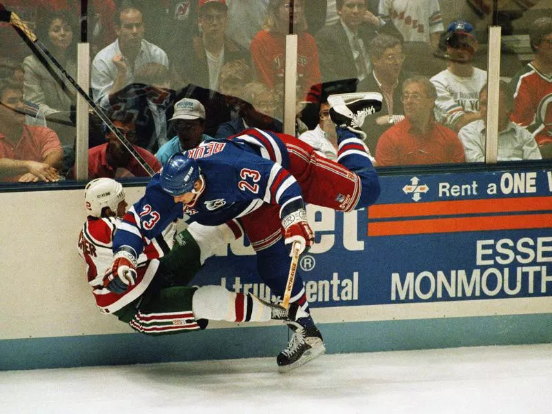 New York Ranger Jeff Beukeboom knocks New Jersey Devil Pat Conacher