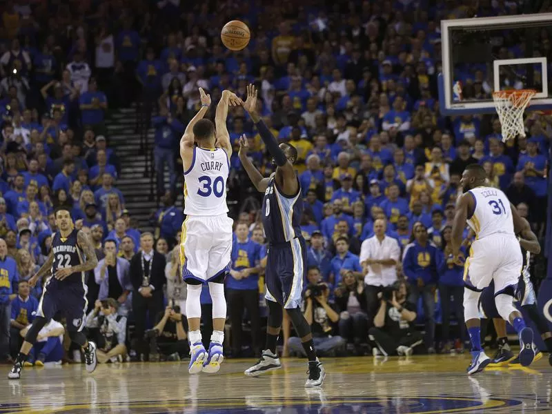 Steph Curry shooting a three-pointer against the Memphis Grizzlies