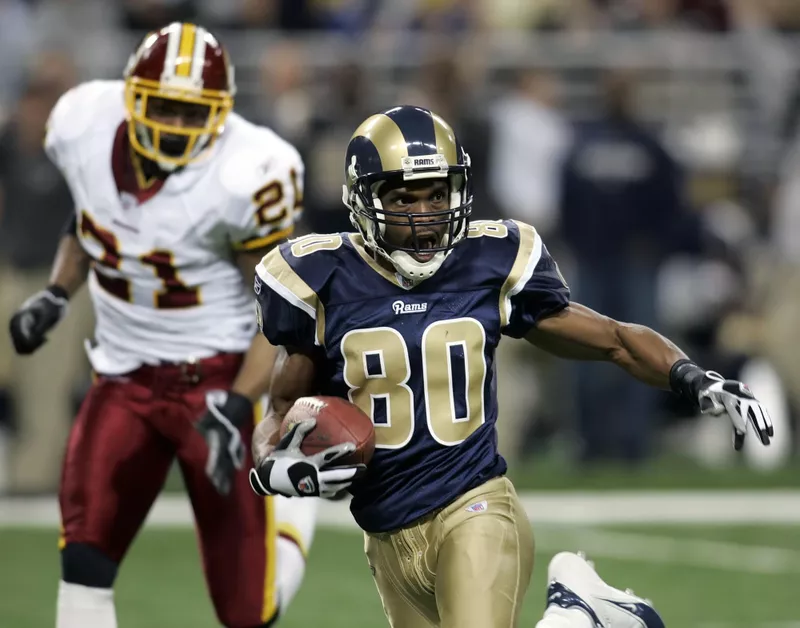 St. Louis Rams' Isaac Bruce eludes Washington Redskins Sean Taylor