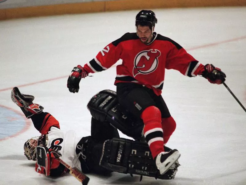 New Jersey Devil Bill Guerin lands on Philadelphia Flyers goalie Ron Hextall