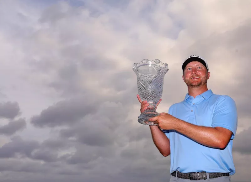 Brice Garnett holding up trophy