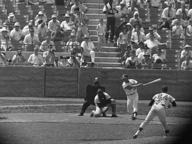 National League batter Maury Wills hits single