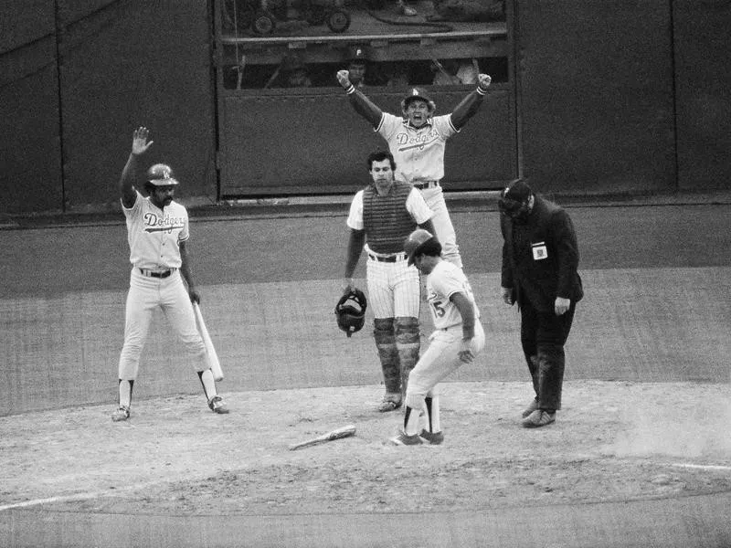 Davey Lopes stomps on home plate and scores for the Dodgers