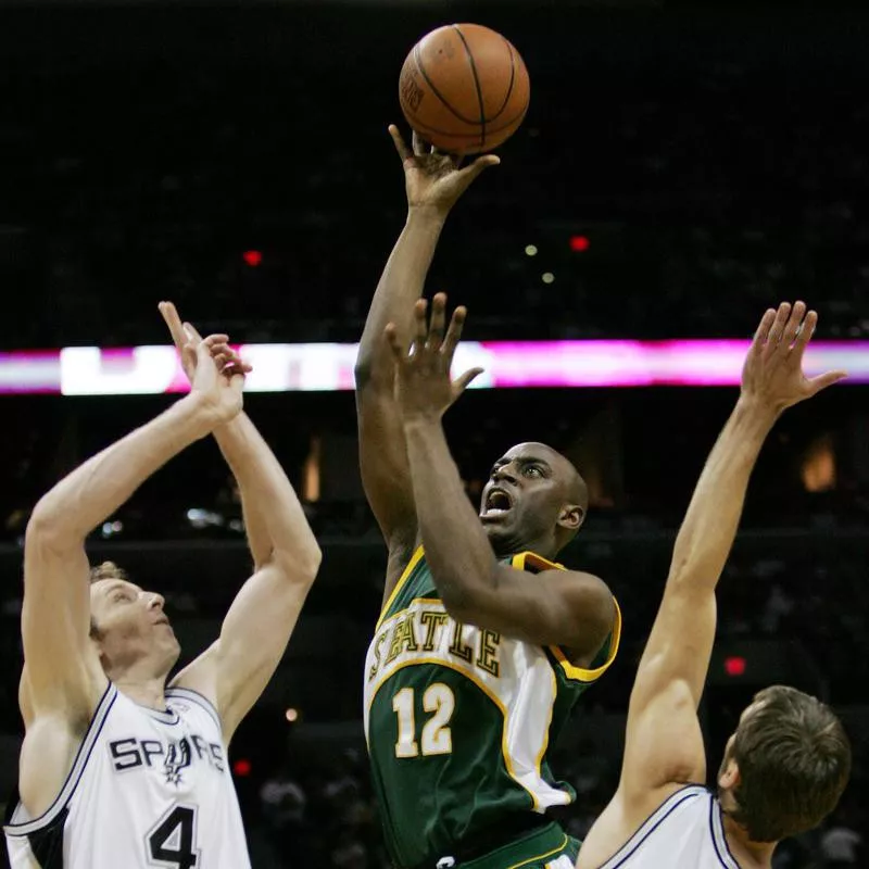 Seattle SuperSonics forward Damien Wilkins drives between San Antonio Spurs defenders