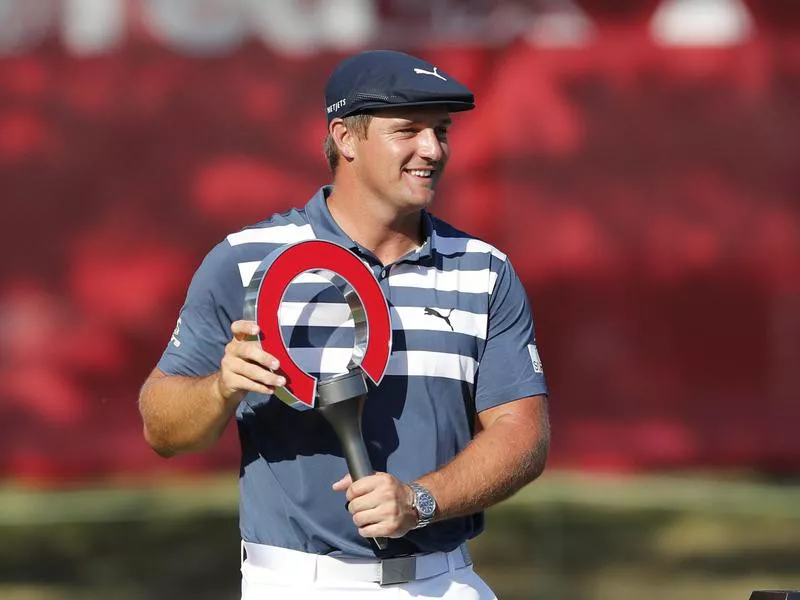 Bryson DeChambeau holds Rocket Mortgage Classic golf tournament trophy